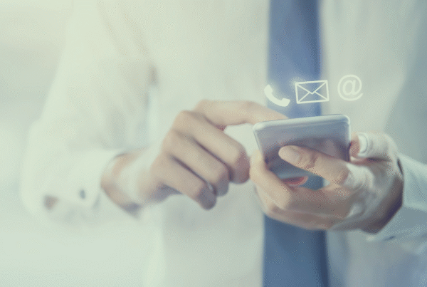 Man holiday a phone with contact us symbols above it for phone, email and chat.
